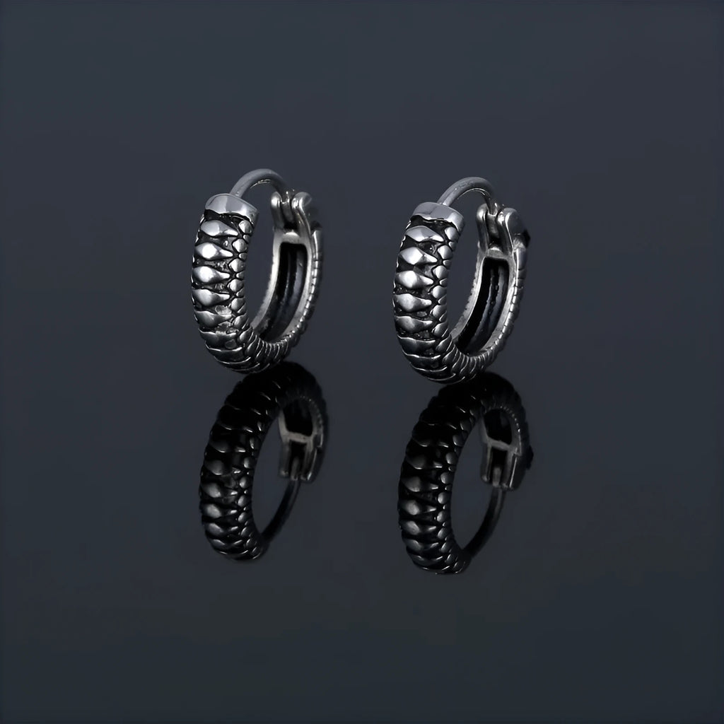 Silver geometric twist earrings with circular elements on white background