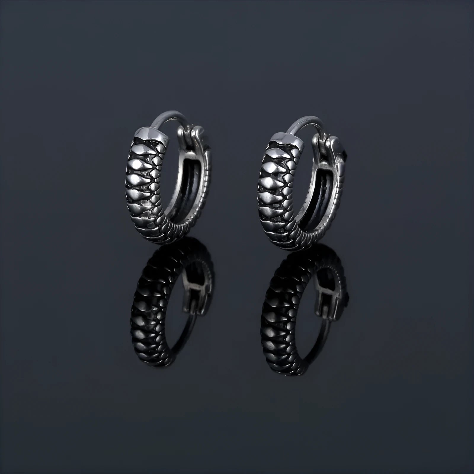 Silver geometric twist earrings with circular elements on white background
