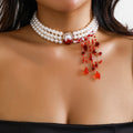 Gold Halloween pearl collar jewellery set with necklace, bracelet, and stud earrings on white background