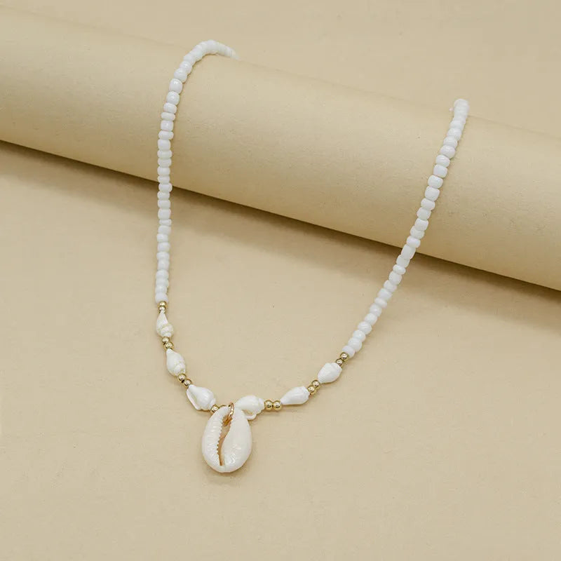 White conch shell bead necklace with mother pearl shellfish pendant on electroplated chain