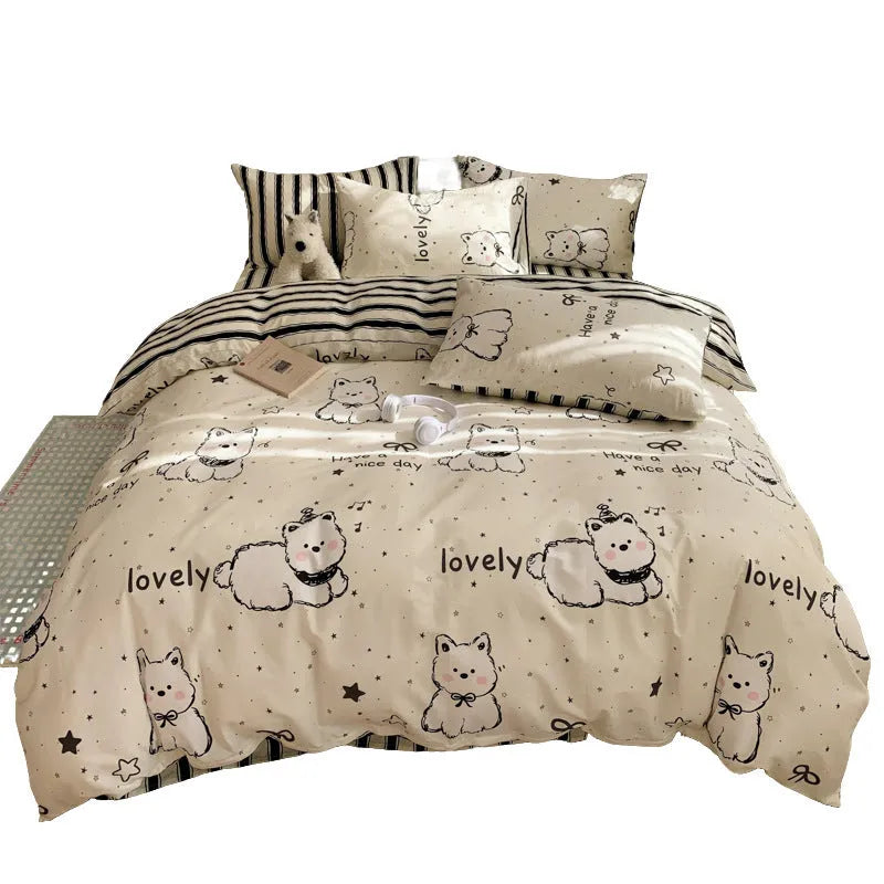 Cartoon dog pattern four-piece pure cotton bedding set laid on a dormitory bed.