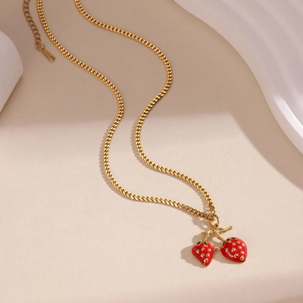 Stainless steel strawberry fruit pendant necklace in red and white gradient colour options.