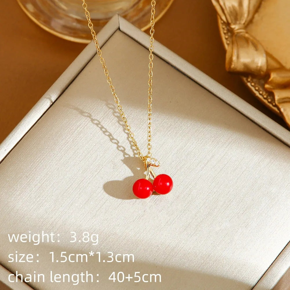 Women's delicate titanium steel necklace with a small cherry charm pendant on an O-ring chain.