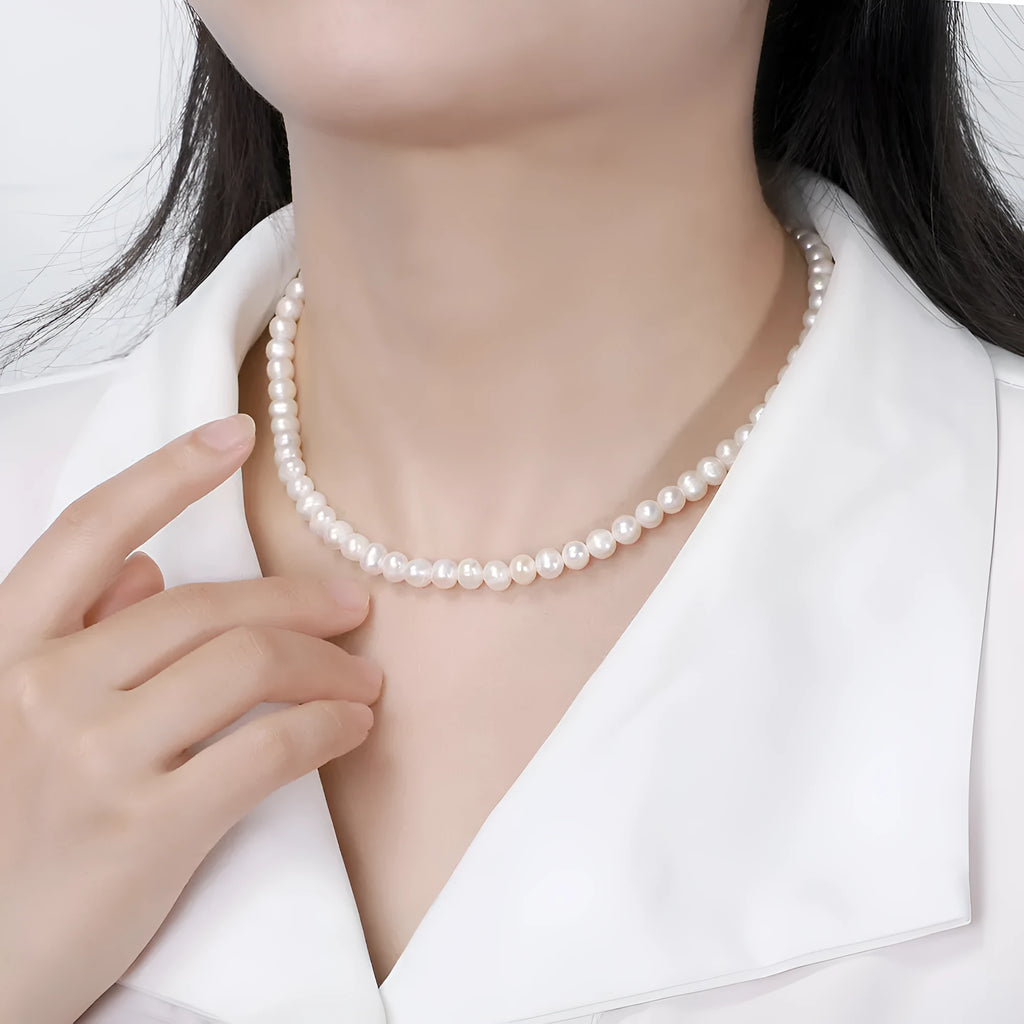 Silver adjustable necklace with freshwater pearl pendant on display