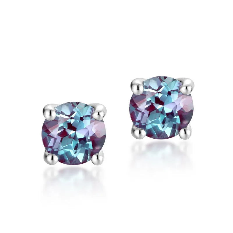 Simple geometric round ear studs in silver with a purple-green cultivate Alexandrite stone.