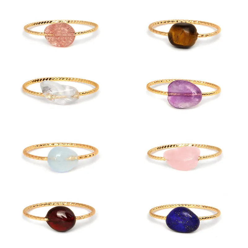 Geometric silver-toned ring setting with a central oval of blue and white banded agate stone on a woman's hand.