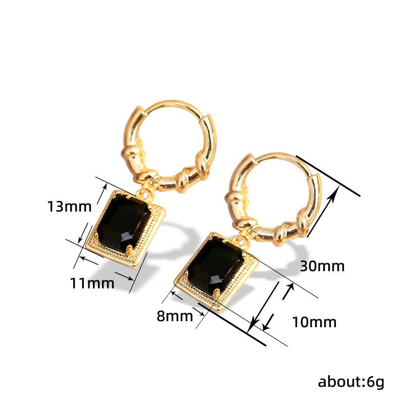 A pair of geometric black zircon earrings with a quadrilateral shape on a copper setting.