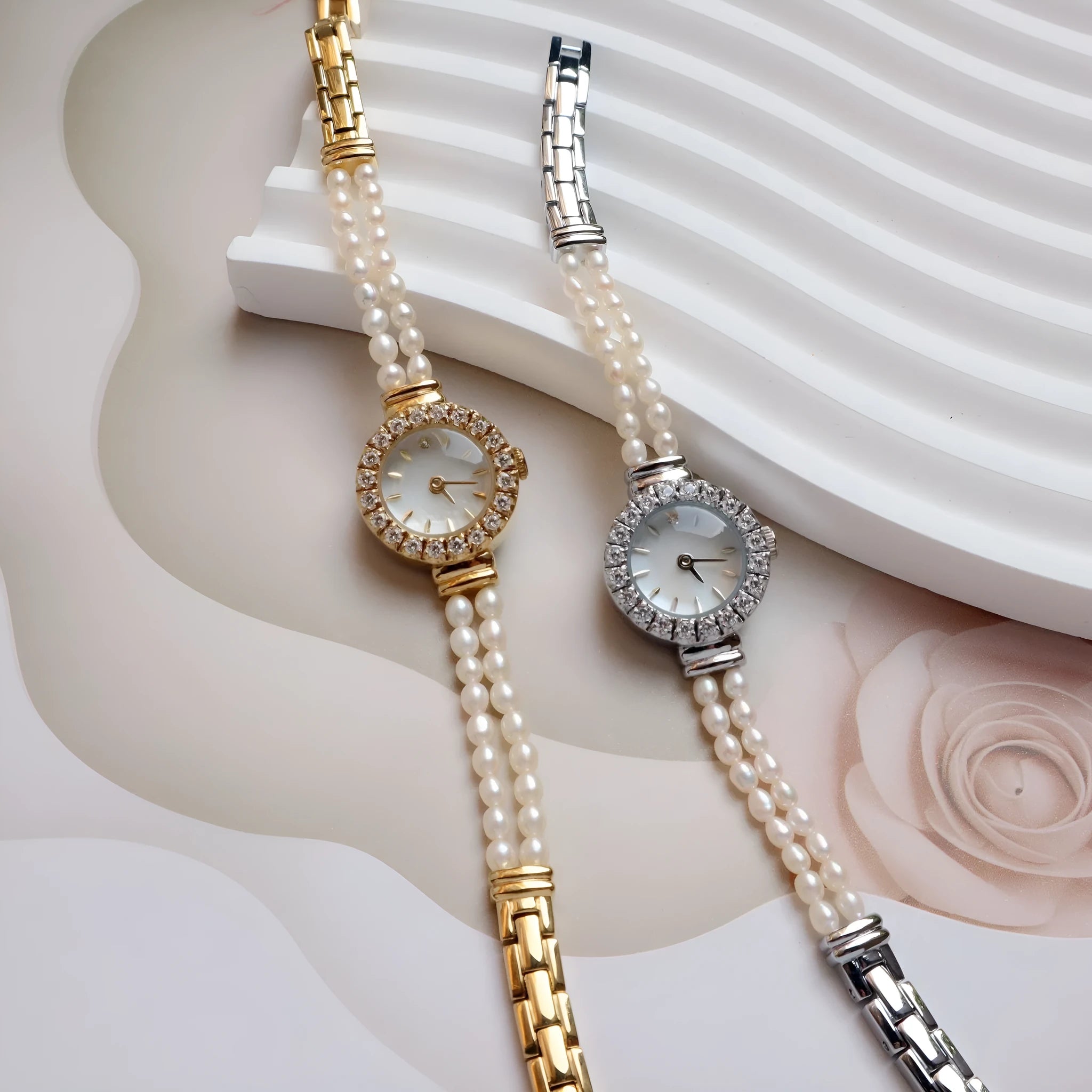 Light gold women's bracelet watch with freshwater pearls on stainless steel strap and round dial.