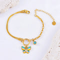 Gold titanium steel butterfly necklace and matching bracelet set on a dark background.