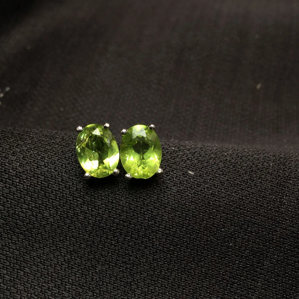 S925 silver stud earrings with a grass green natural olivine gemstone, elliptical cut.