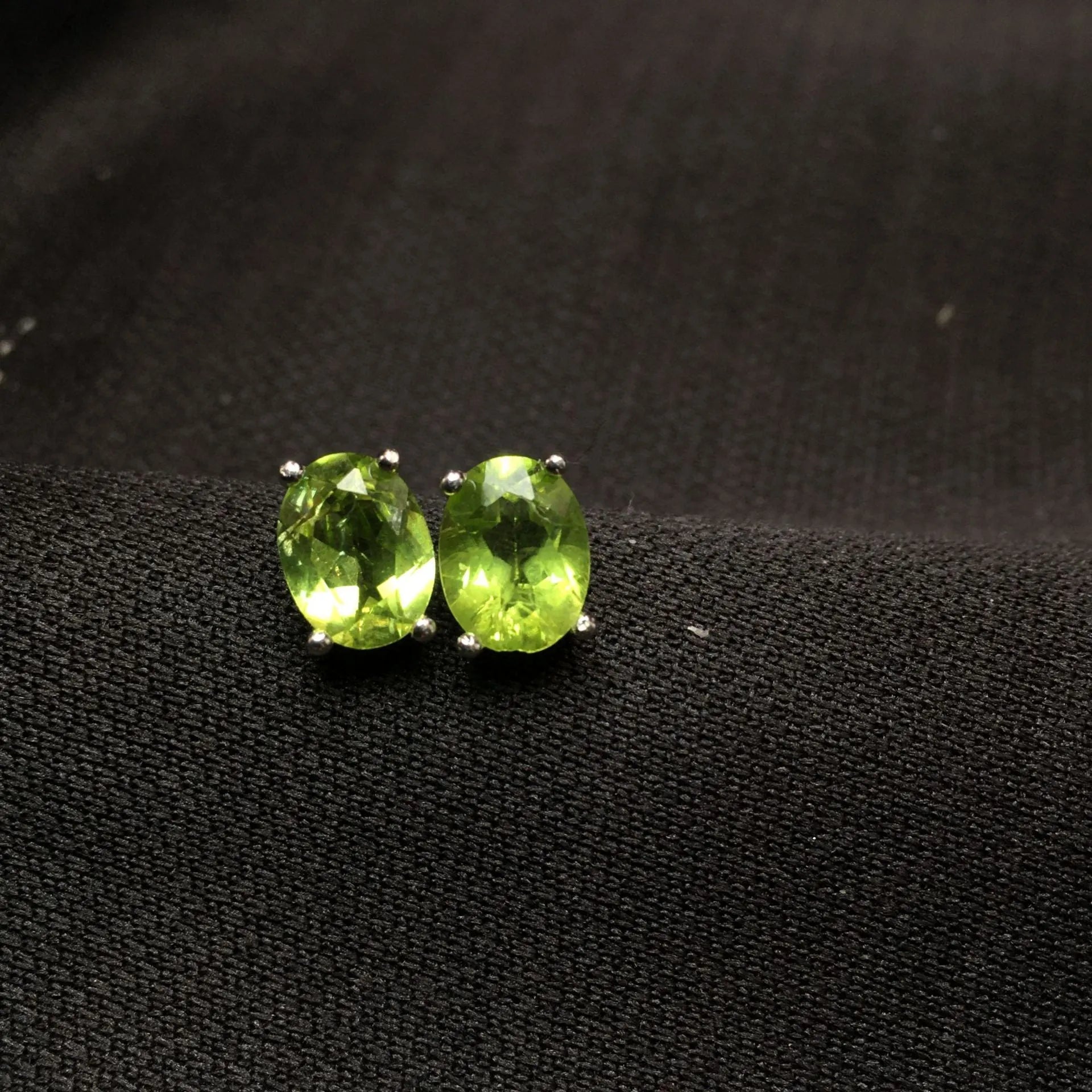 S925 silver stud earrings with a grass green natural olivine gemstone, elliptical cut.