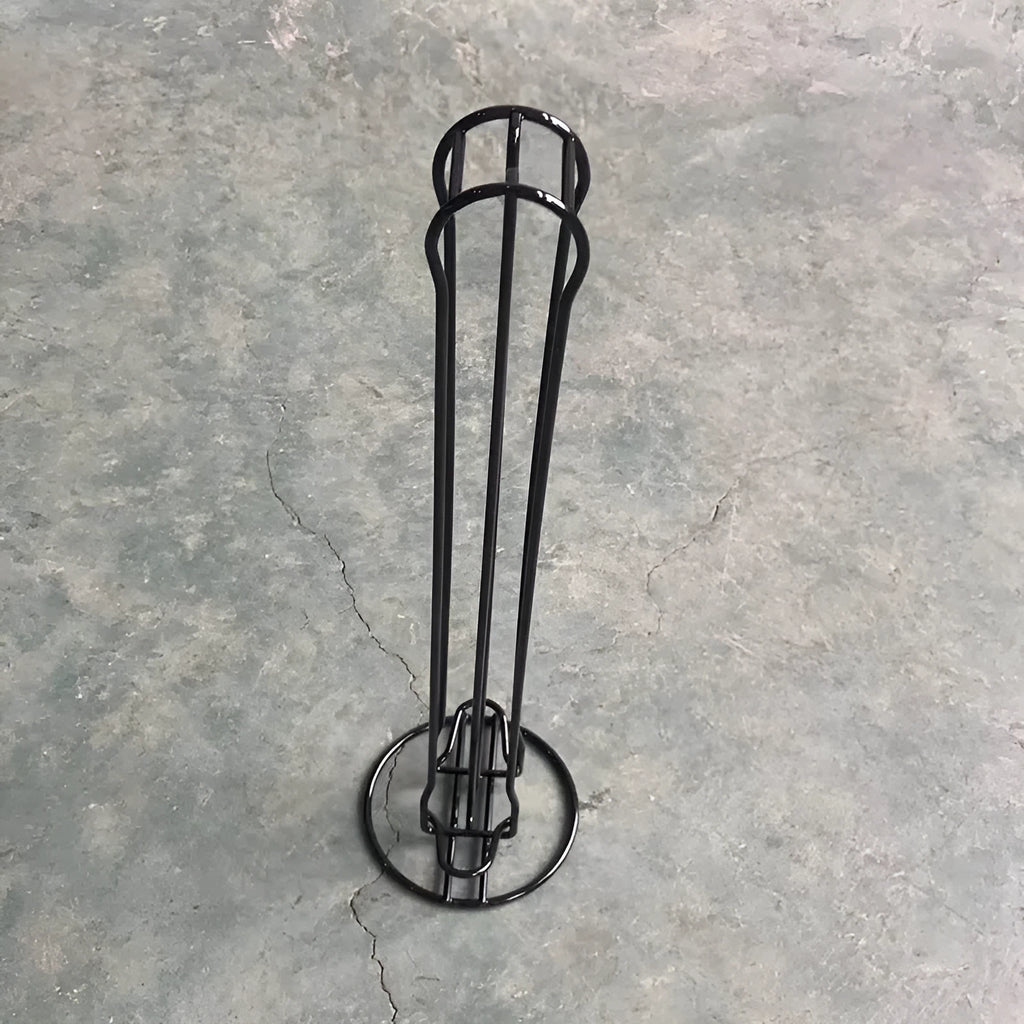 Wrought iron coffee capsule storage rack holding pods, in spray black finish.