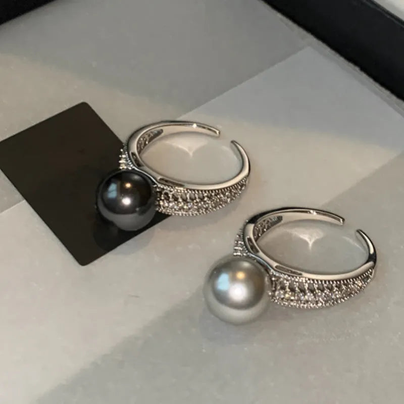 Geometric copper ring with black pearl and adjustable opening for women.