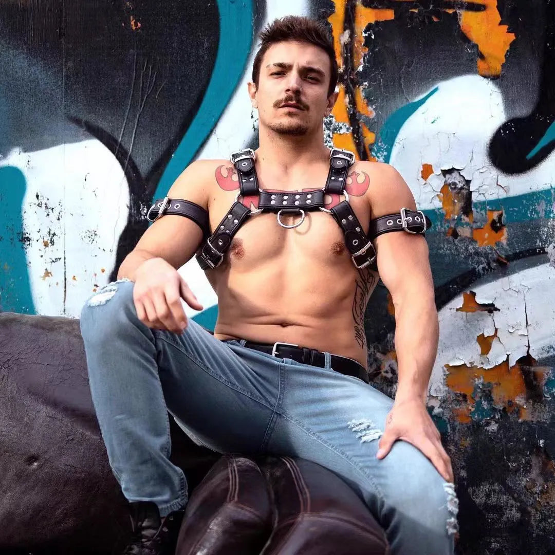 Black leather chest harness with metal buckles and adjustable straps for muscle bondage styling
