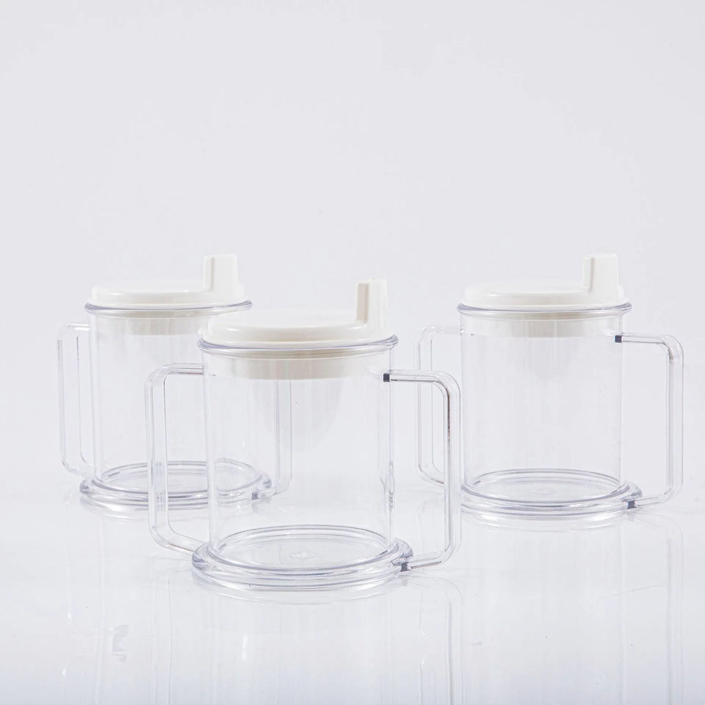 Transparent plastic drinking cup with a lid on a solid background.