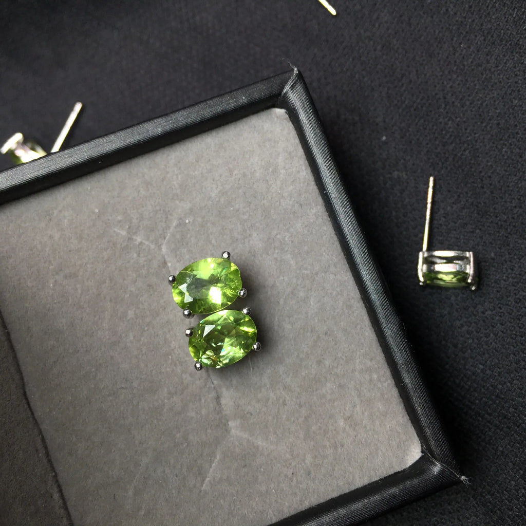 S925 silver stud earrings with a grass green natural olivine gemstone, elliptical cut.