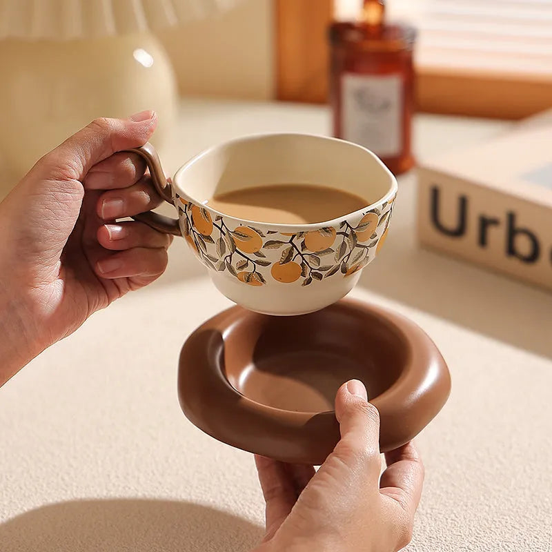 Antique style ceramic coffee cup and saucer set with medieval pattern in black or orange