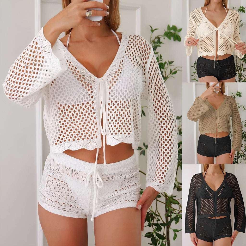 Short apricot coloured women's cardigan blouse with long bell sleeves on a hanger.