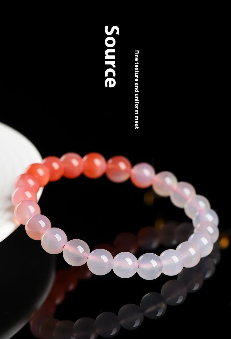 Natural gradient Yanyuan agate bracelet with geometric polished beads on a wrist, showing salt source colour variation.
