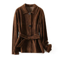 Yellow brown retro cashmere coat with Peter Pan collar, leather stitching, and a belt on a hanger.