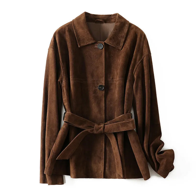 Yellow brown retro cashmere coat with Peter Pan collar, leather stitching, and a belt on a hanger.