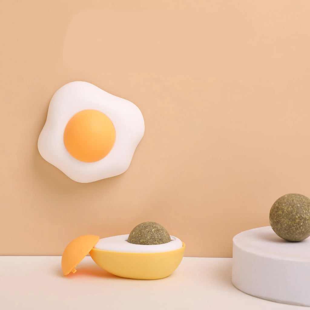 Interactive catnip ball toy in egg shapes for wall attachment and teeth cleaning