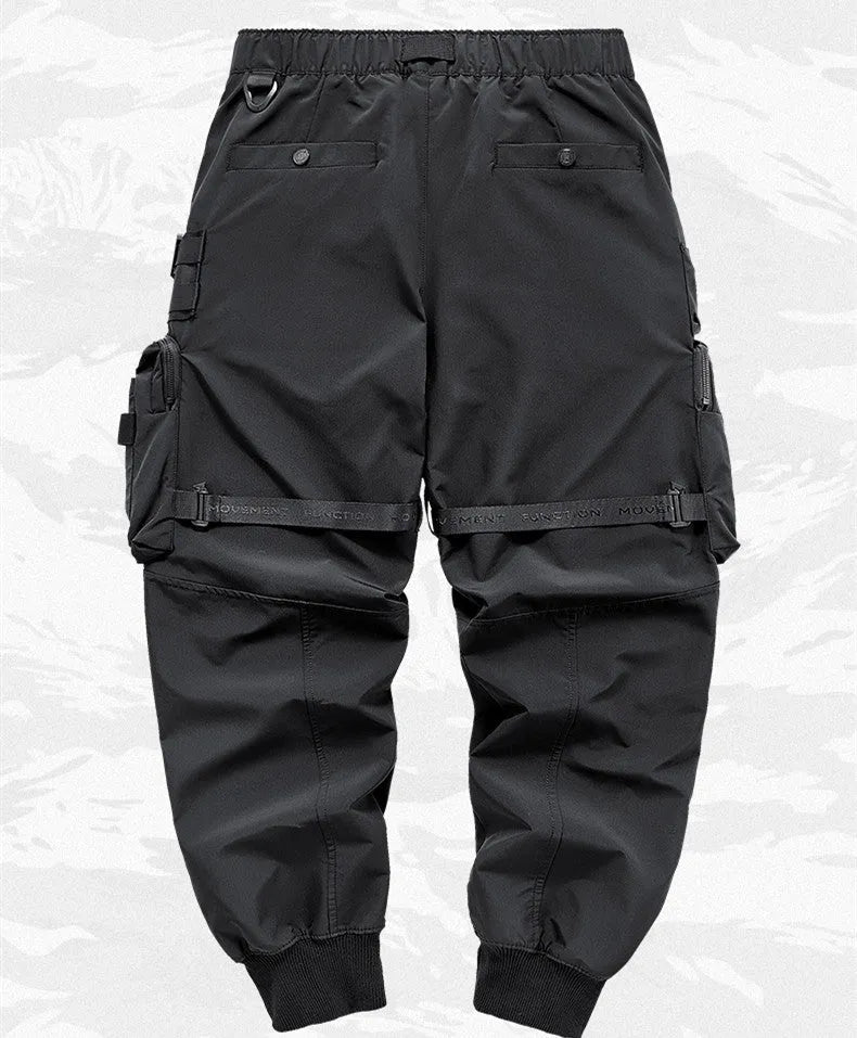 Men's black multi pocket cargo pants in polyester, loose fit, mid-waist style, on white background