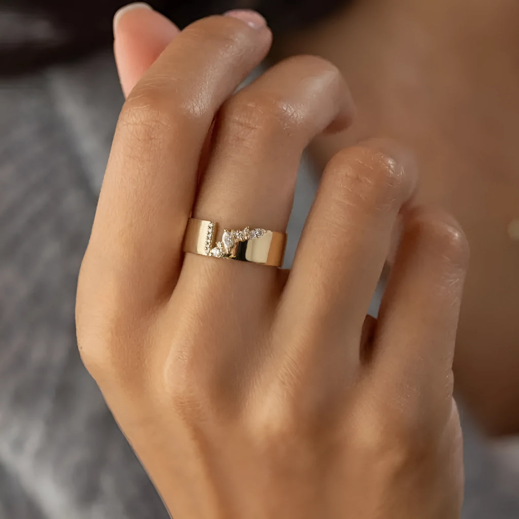 Gold electroplated women's ring with shining zircon stones on a copper band.
