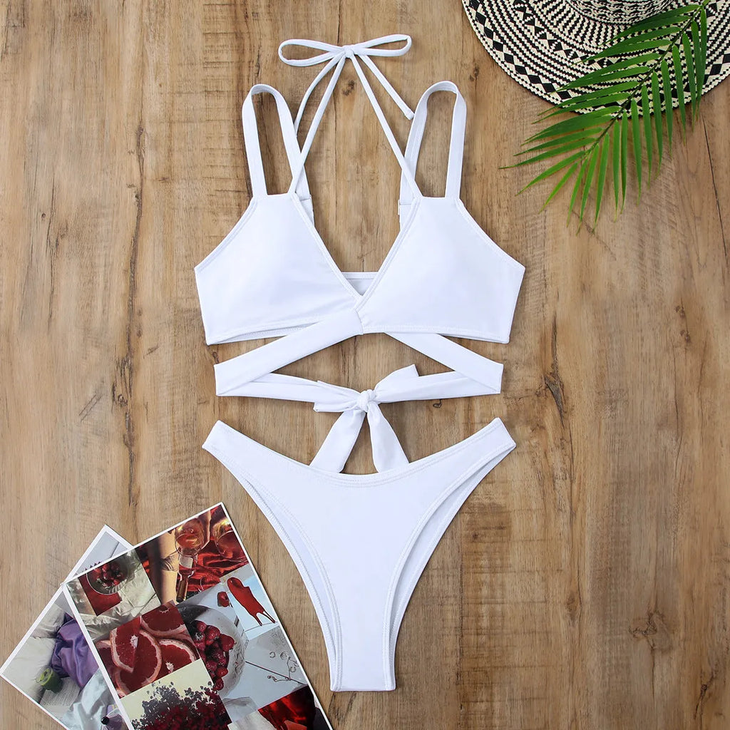 Women's solid colour strappy bikini swimsuit in black, blue, red, rose red, or white on a mannequin.