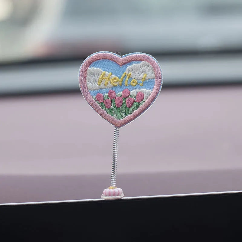 Six yellow PVC duckling car decorations with Hello sign on car dashboard