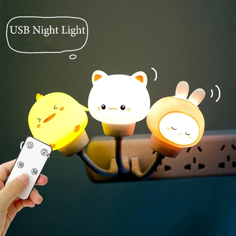 USB portable cartoon animal LED night light with remote control on a bedside table