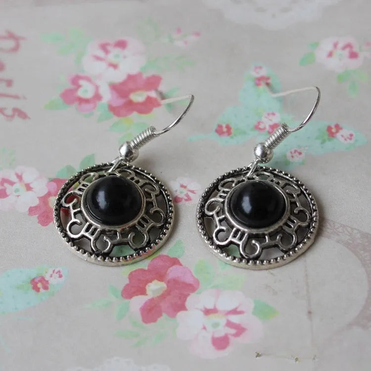 Handmade Tibetan silver earrings with turquoise geometric flower disk design in Miao ethnic style
