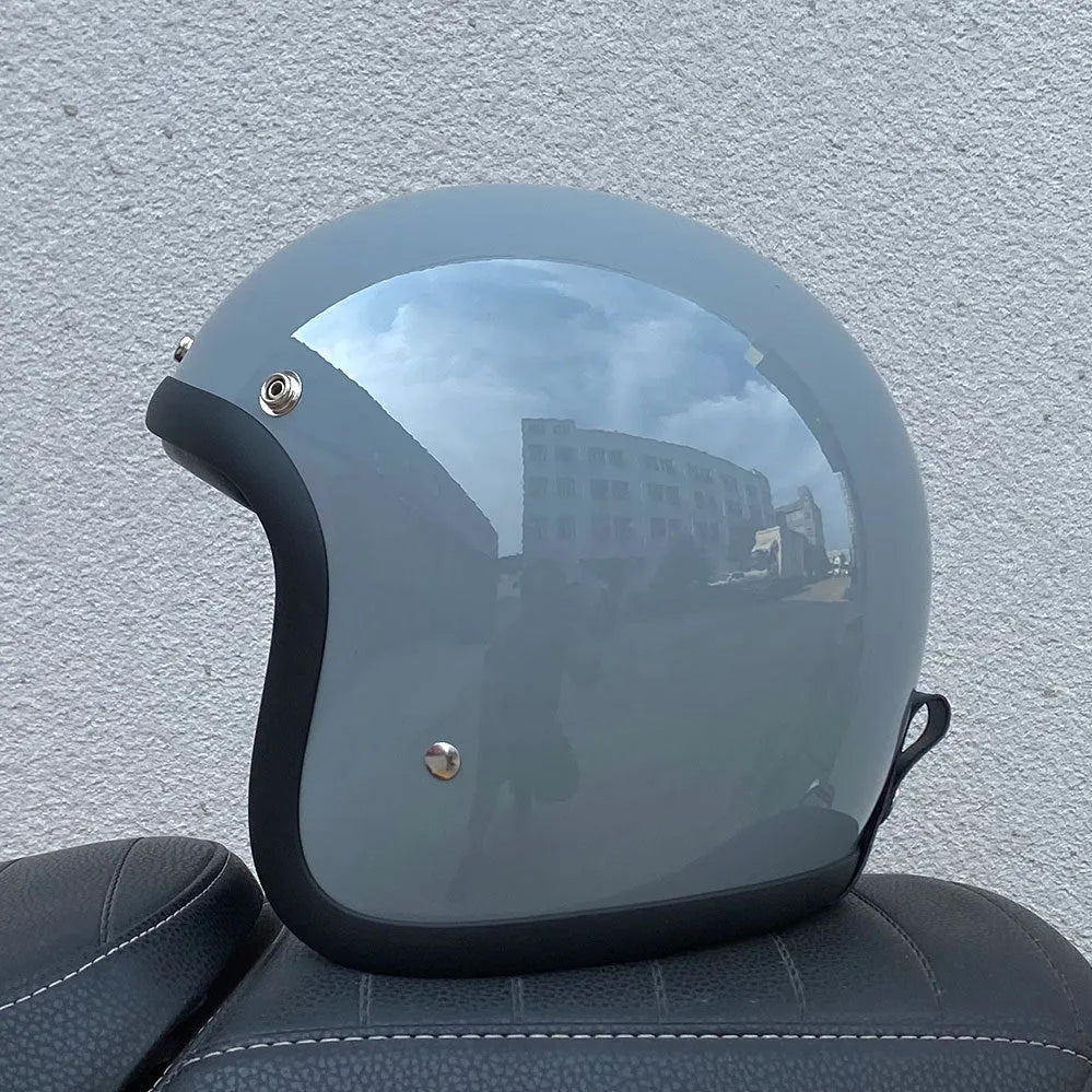 Glass fibre retro half motorcycle helmet shown in various colours including cement gray and matte black options