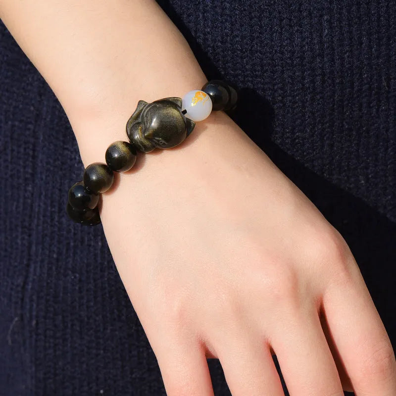 Natural obsidian zodiac guardian bracelet with 10mm beads on an adjustable cord.