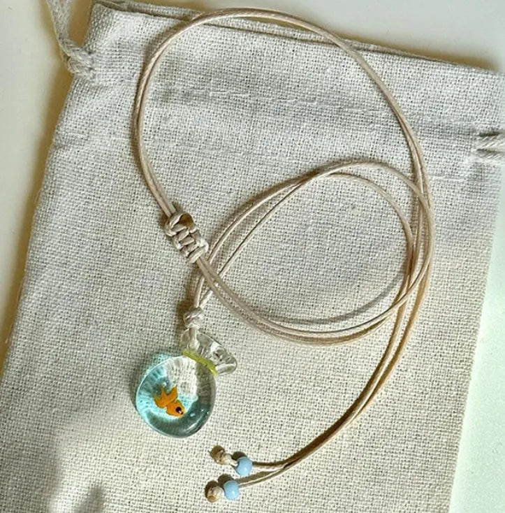 Women's skirt and joker charm pendant necklace with coloured glass on a cotton linen clavicle chain.