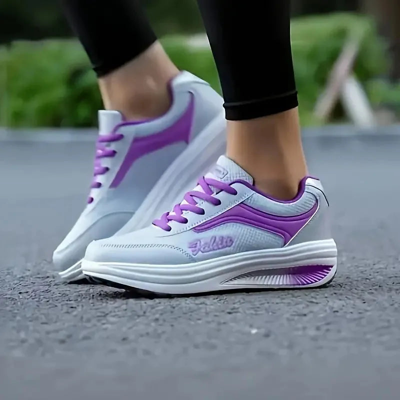Women's heelless sports shoes in a mid-heel design, shown in a choice of colours including black and pink.