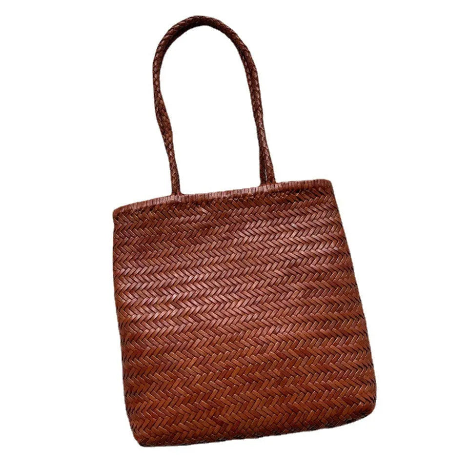 Brown woven leather tote bag with three-dimensional pockets and shoulder straps