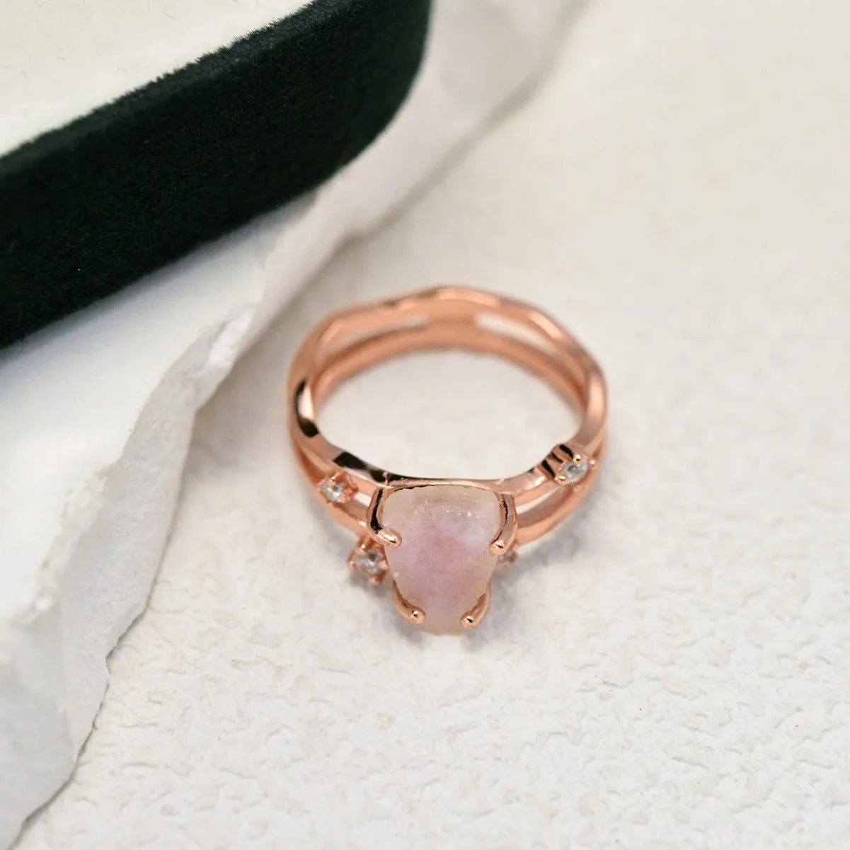 S925 sterling silver ring with irregular triangle design holding a moonstone, shown in rose gold plating.