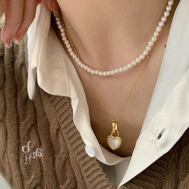 Double-sided shell love pendant necklace with mixed gem inlay on adjustable chain, available in gold-plated copper or titanium steel