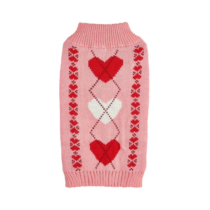 Small dog wearing an acrylic sweater with pink bow and love heart design