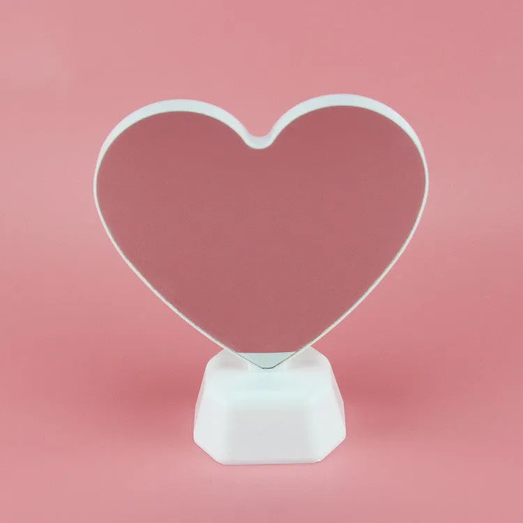 Rose red double-sided love tunnel shape LED decorative light on a flat surface.