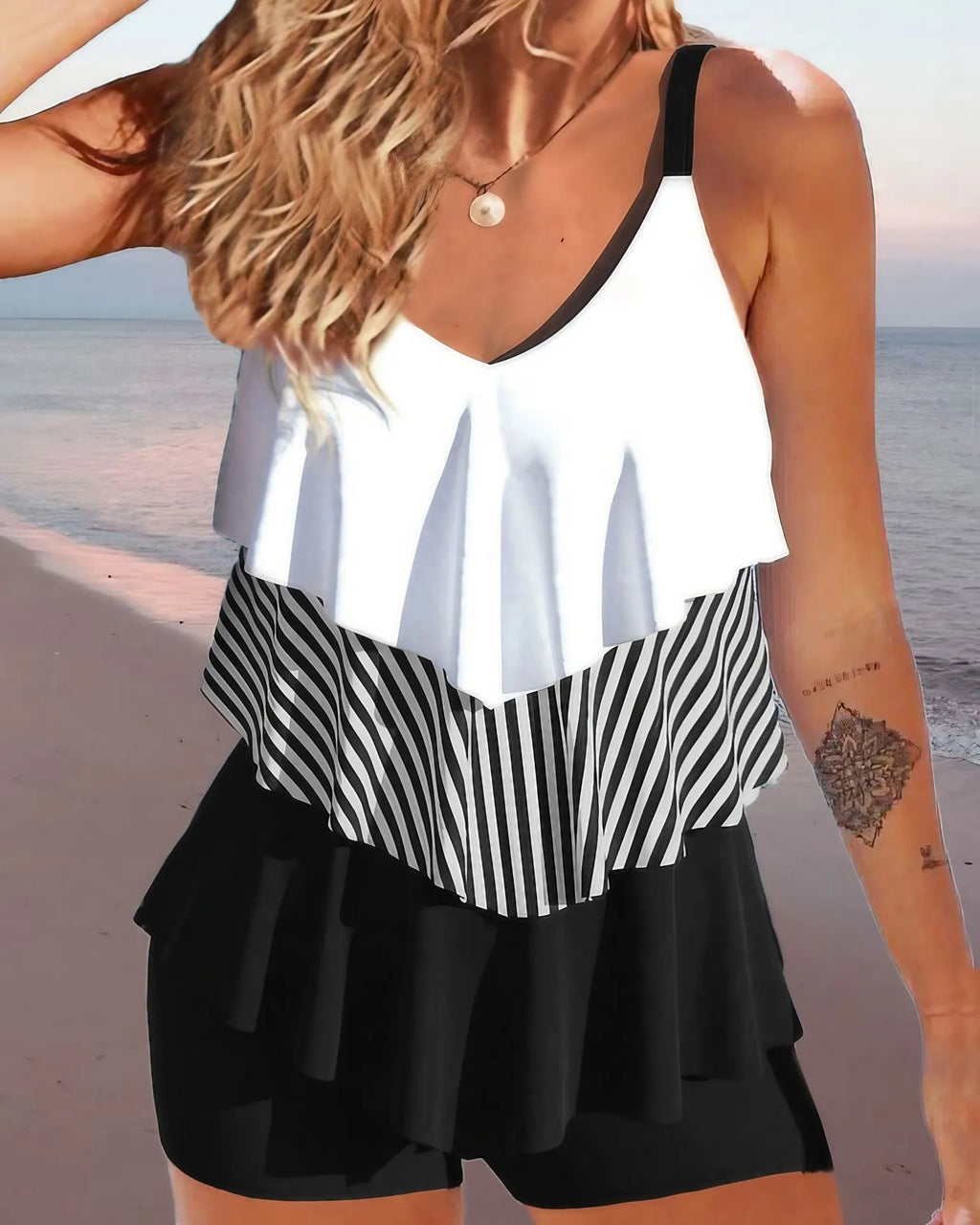 Women's sleeveless ruffle bikini swimsuit in a floral print on a mannequin.