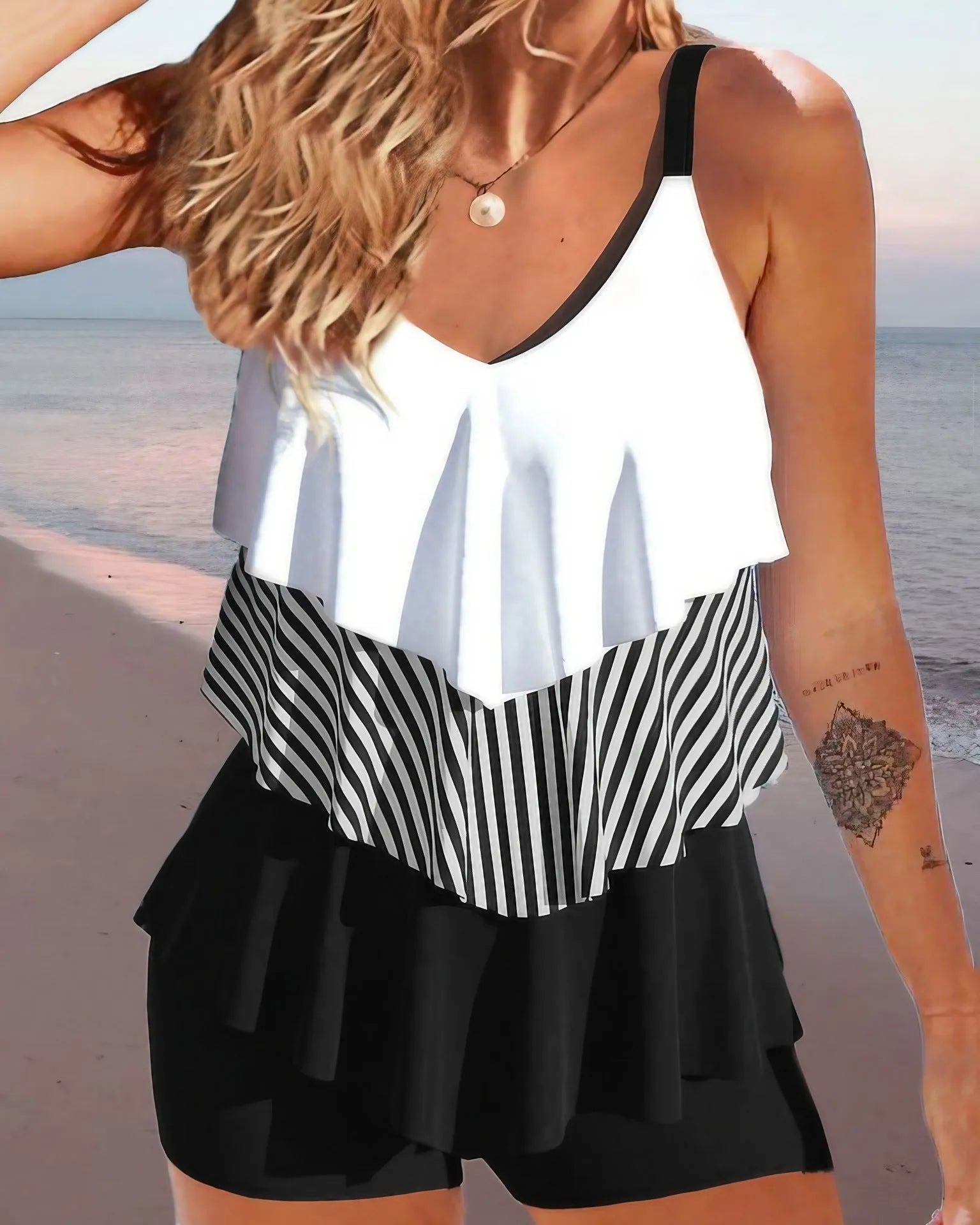 Women's sleeveless ruffle bikini swimsuit in a floral print on a mannequin.