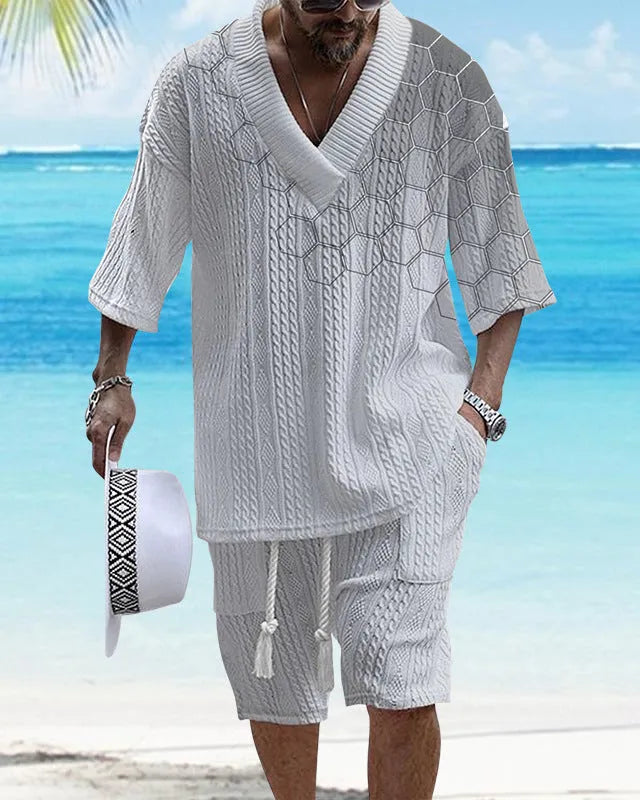 Man wearing a printed drop-shoulder knitted top and matching shorts from a two-piece lounge suit.