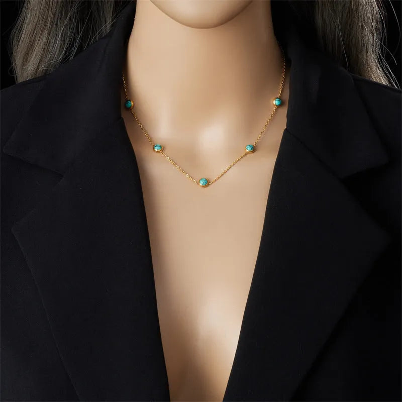 Round turquoise stainless steel earrings and necklace set on display