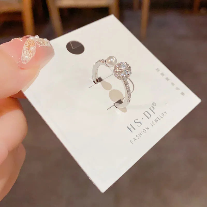 Geometric open-end ring with round zircon accents in gold or silver finish