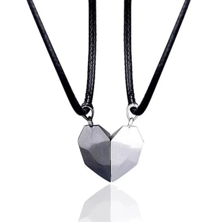 Gold-plated magnetic faceted heart pendant necklace in black and white on display