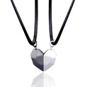 Gold-plated magnetic faceted heart pendant necklace in black and white on display