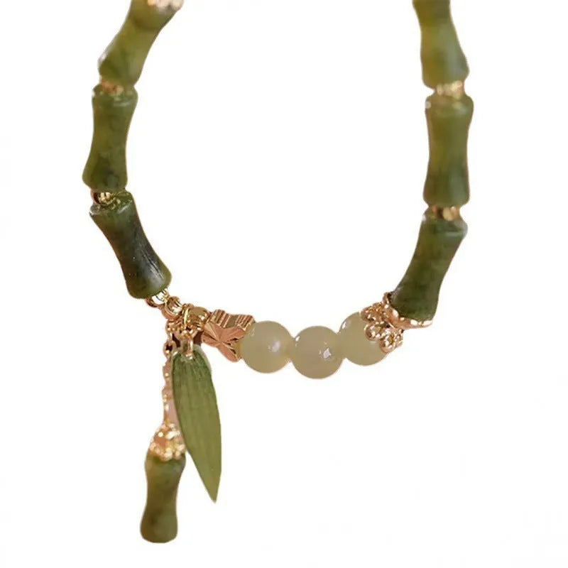 Chinese style glass bead bracelet with bamboo leaf design and manual craftsmanship details.