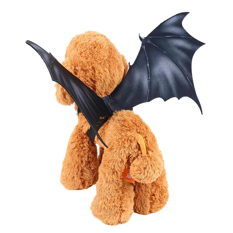 Black cloth bat wing costume for a cat or dog, showing large wing span.